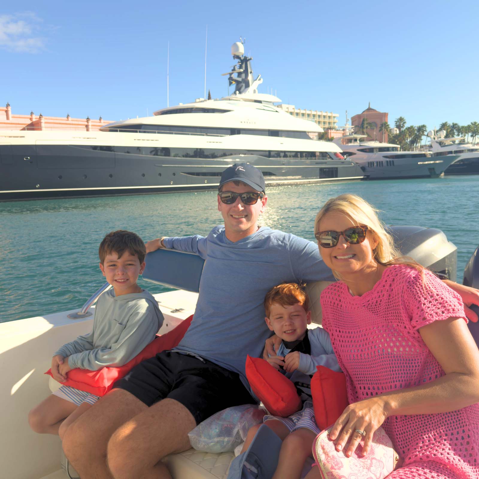 Happy family enjoying a private boat tour in Nassau Bahamas